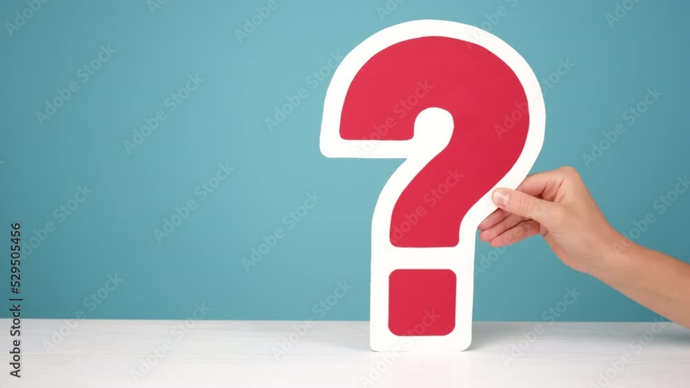 Close up of female hands holding big question mark sign at desk, posing on blue background wall in studio with copy space for promotion content. Business, plans, thoughts and advertisement concept Close up of female hands holding big question mark sign at desk, posing on blue background wall in studio with copy space for promotion content. Business, plans, thoughts and advertisement concept