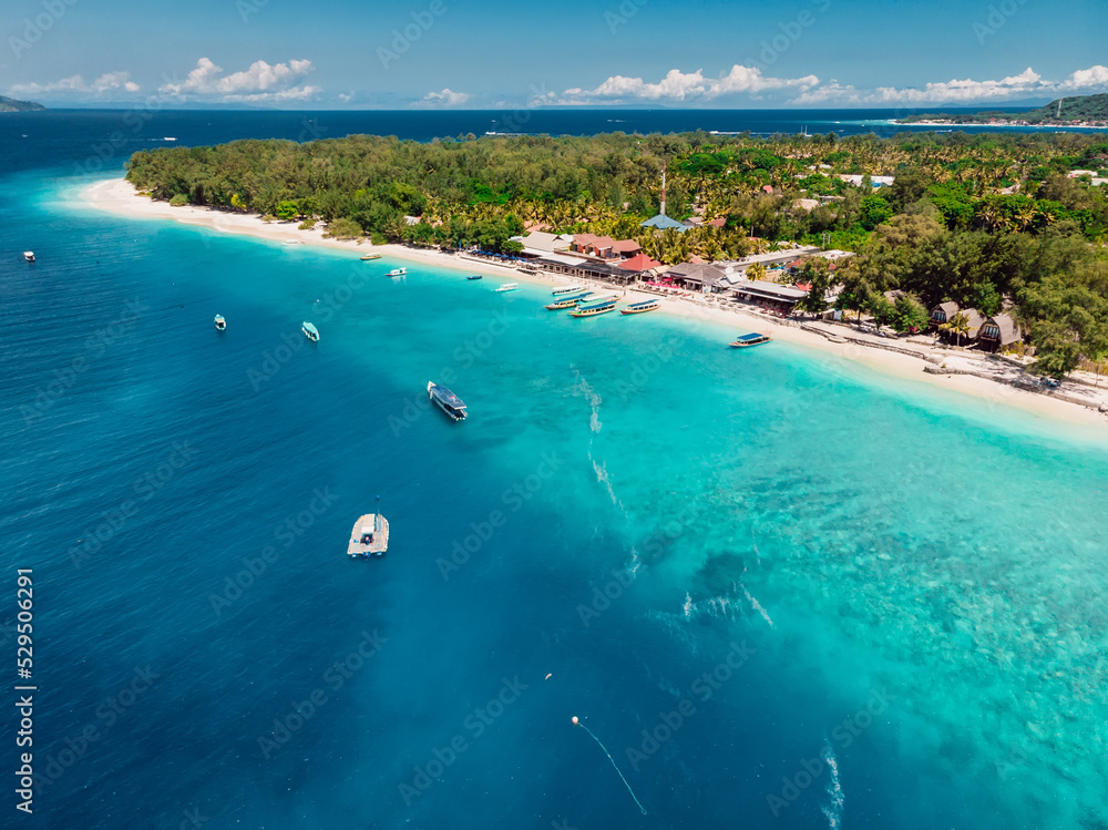 Tropical beach, blue ocean and boats. Aerial view.