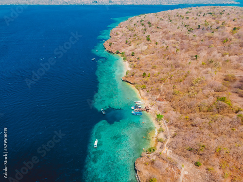 Popular diving sites in transparent ocean on Menjangan island. Aerial view.
