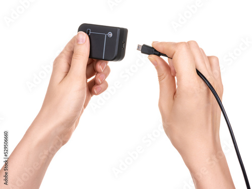 Wallpaper Mural Female hands hold a debugger flasher with a usb port for program chips and memory and insert a usb cable with a connector. Isolated on white background. Torontodigital.ca