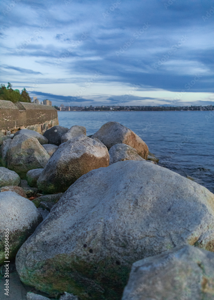 Sunset scenic over the beach with rocks. Beautiful sunset at the Pacific ocean Canada.