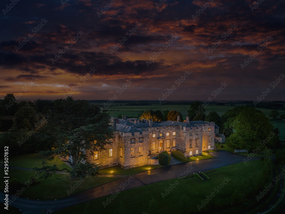 Hazlewood Castle, North Yorkshire historic castle at night. Aerial drone photograph of the front of the castle and moody sky. Close to Leeds and York, Yorkshire, england, united kingdom