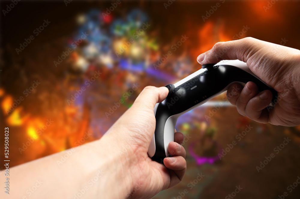 Fototapeta premium Video games. On a fantasy background, a joystick in the hands of a gamer. Fun entertainment, online games with friends, youth culture, prizes, win. Advertising, banner.