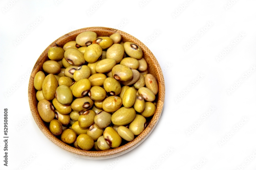 Yellow Ball Beans (Phaseolus vulgaris) in a wooden bowl, isolated, top view on a white background. Yellow Ball Beans (Phaseolus vulgaris) in a wooden bowl, isolated, top view on a white background.