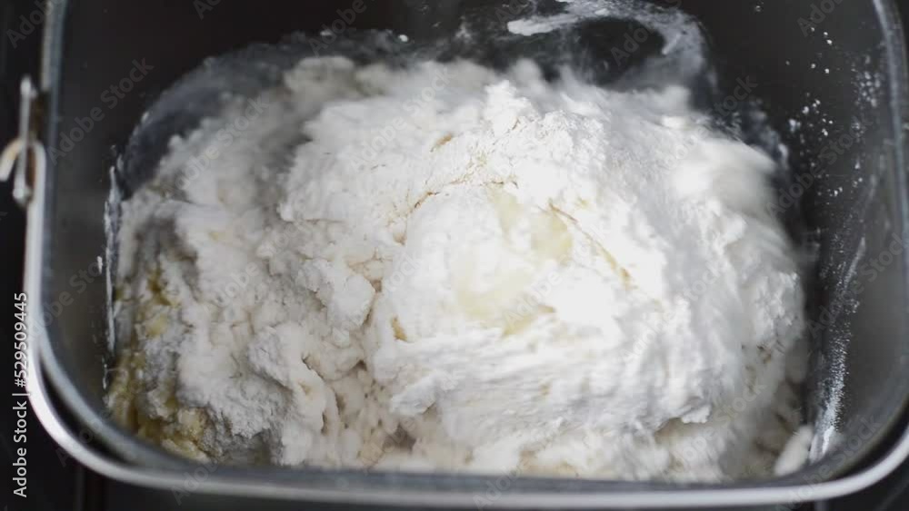 The process of making dough in a bread machine. Step by step baking homemade bread. Close-up The process of making dough in a bread machine. Step by step baking homemade bread. Close-up