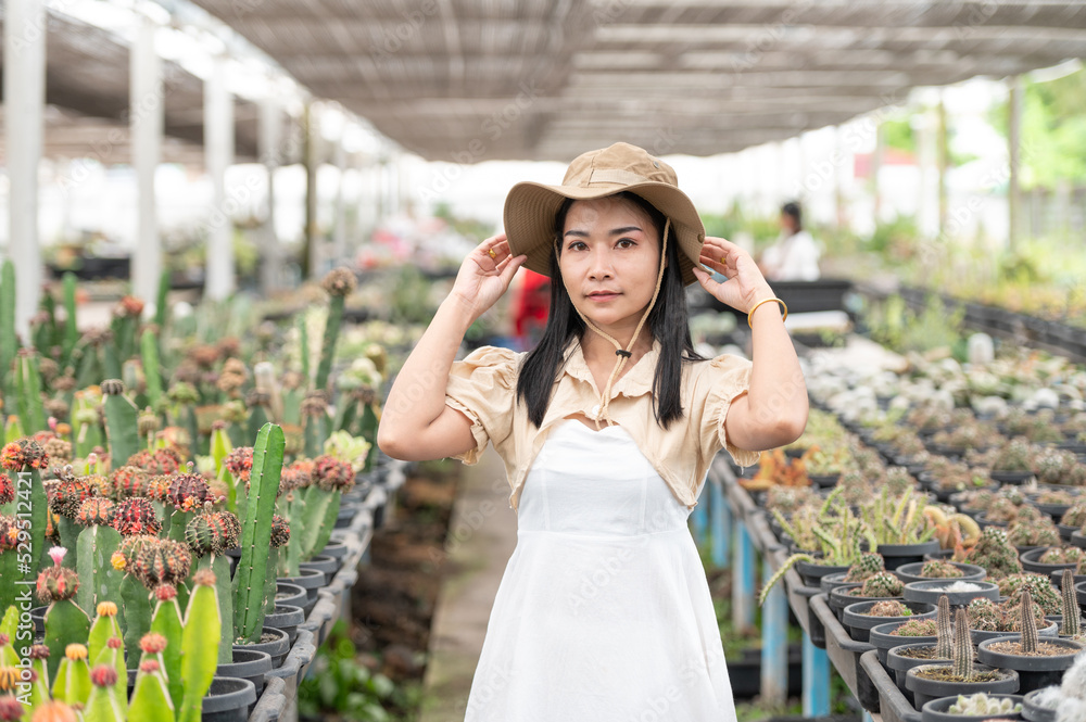 Beautiful Asia woman cross arm in cactus farm.
