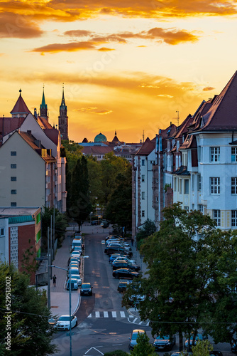 Stampa su tela View through the streets of Nuremberg during an orange sunset