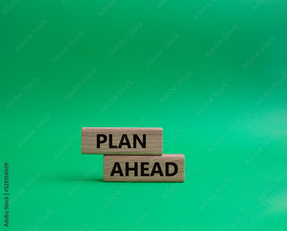 Plan ahead symbol. Wooden blocks with words Plan ahead. Beautiful green background. Businessman hand. Business and Plan ahead concept. Copy space. Plan ahead symbol. Wooden blocks with words Plan ahead. Beautiful green background. Businessman hand. Business and Plan ahead concept. Copy space.