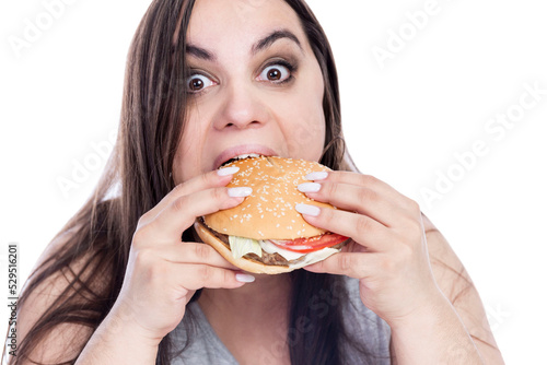 Overweight woman with appetite greedily eats hamburger. Obesity and fast food. Isolated on white background. Close-up.