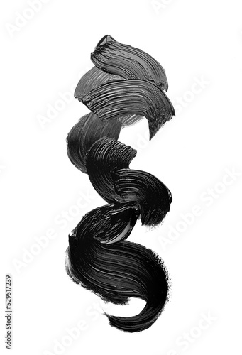 Black glossy strokes of oil or acrylic paint isolated on a black matte background, abstract shapes.