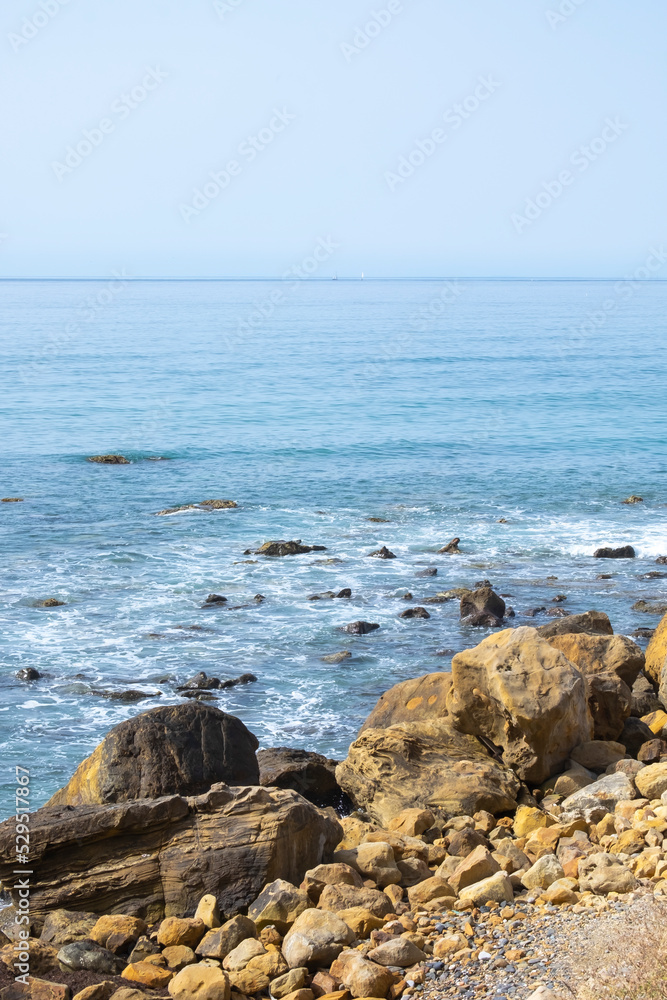 Sea waves crashing on rocks of the beach. Sea waves breaking on Maditerranean's shore.