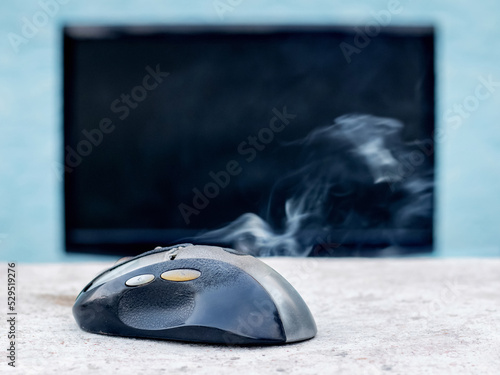 Quadro em tela Smoke is coming from the computer mouse near the computer due to a malfunction