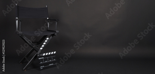 Black Director chair and black clapper board or movie slate on black blackground. photo