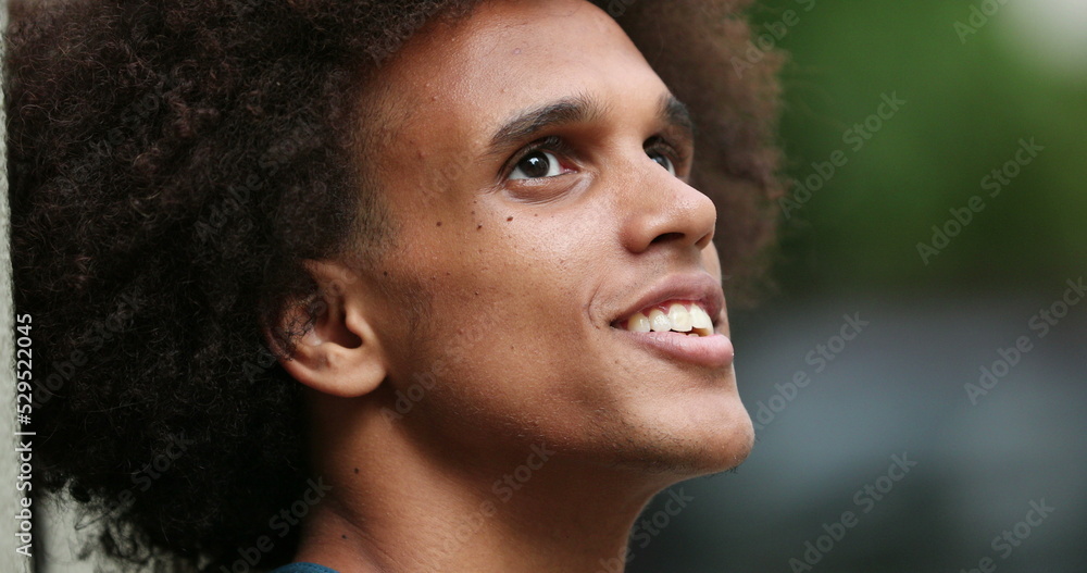 Contemplative happy young african man candid Contemplative happy young african man candid