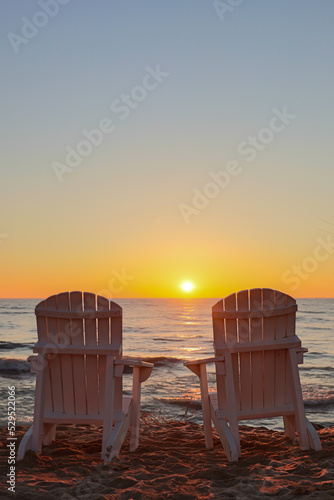 Adirondack chairs at summer sunrise