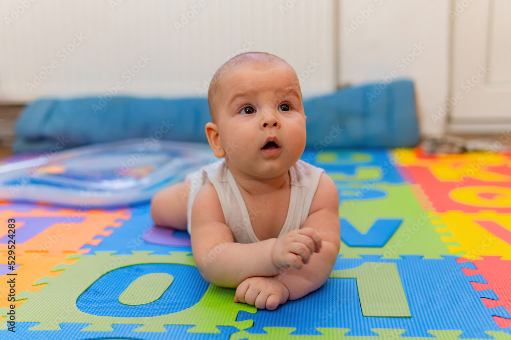 small cute 6 month baby boy looking up small cute 6 month baby boy looking up