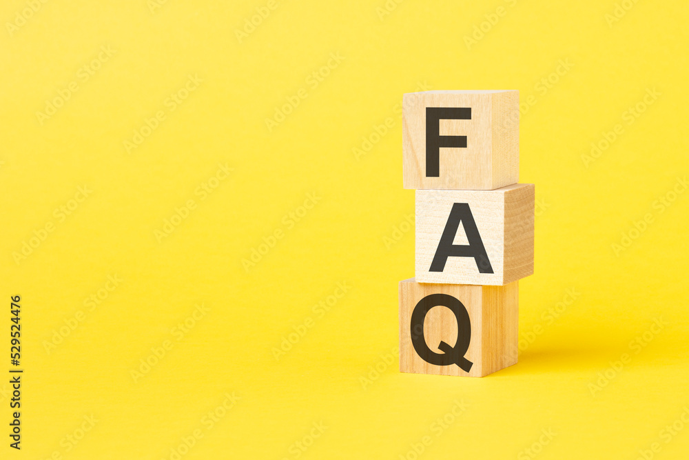 FAQ - text on wooden cubes, on yellow background