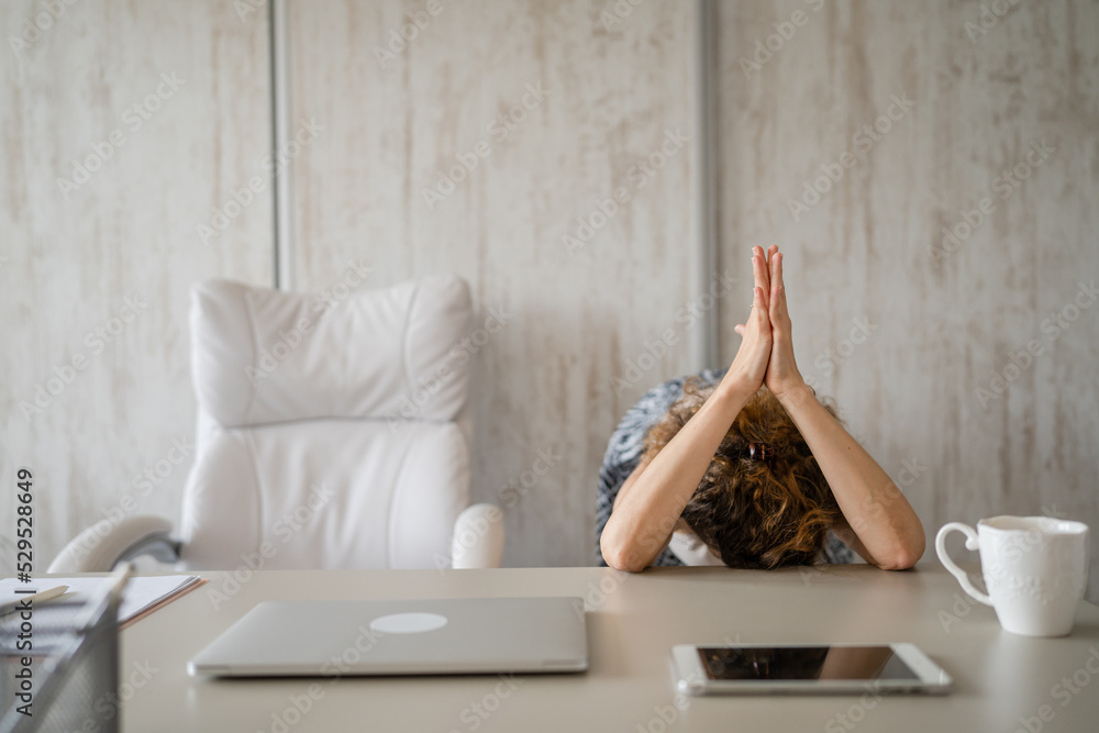 young woman stretching at work while sitting at desk having back pain young woman stretching at work while sitting at desk having back pain