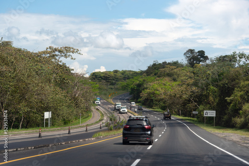 Cars on a highway between tropical forest in Colombia.
