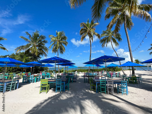 A typical beach restaurant with colorful tables  chairs and umbrellas in the Florida Keys.