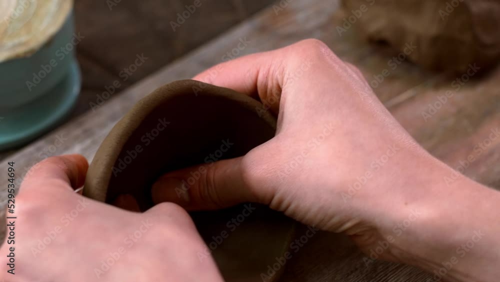girl kneads the clay to make a clay sculpture of her. occupation in pottery. High quality 4k footage girl kneads the clay to make a clay sculpture of her. occupation in pottery. High quality 4k footage