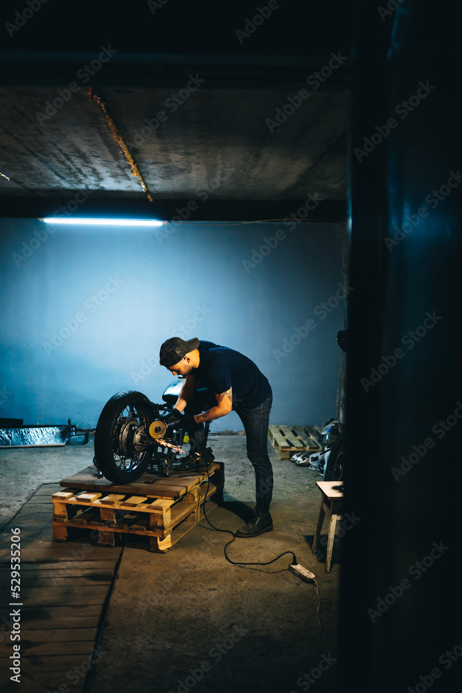 Fototapeta premium Motorcycle repair. Disassembled motorcycle. Fixing motorcycle standing in repair shop. Instruments and equipment. 