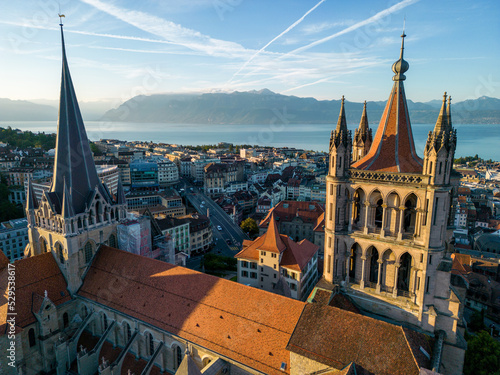 August 22nd 2022, Lausanne, Switzerland. A drone aerial shot of Lausanne cathedral and Lake Geneva at sunrise. photo