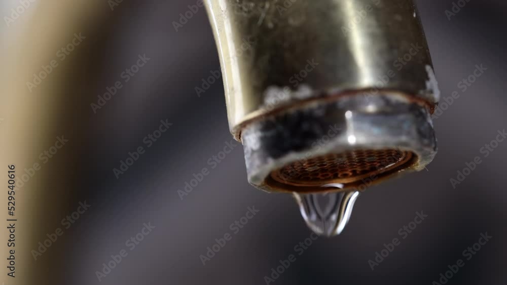 Water Dripping From Faucet. Drop Of Water Drips From The Water Vintage Bronze Tap In A Kitchen. Macro. Close-up. 60 FPS, 4k, ProRes Water Dripping From Faucet. Drop Of Water Drips From The Water Vintage Bronze Tap In A Kitchen. Macro. Close-up. 60 FPS, 4k, ProRes