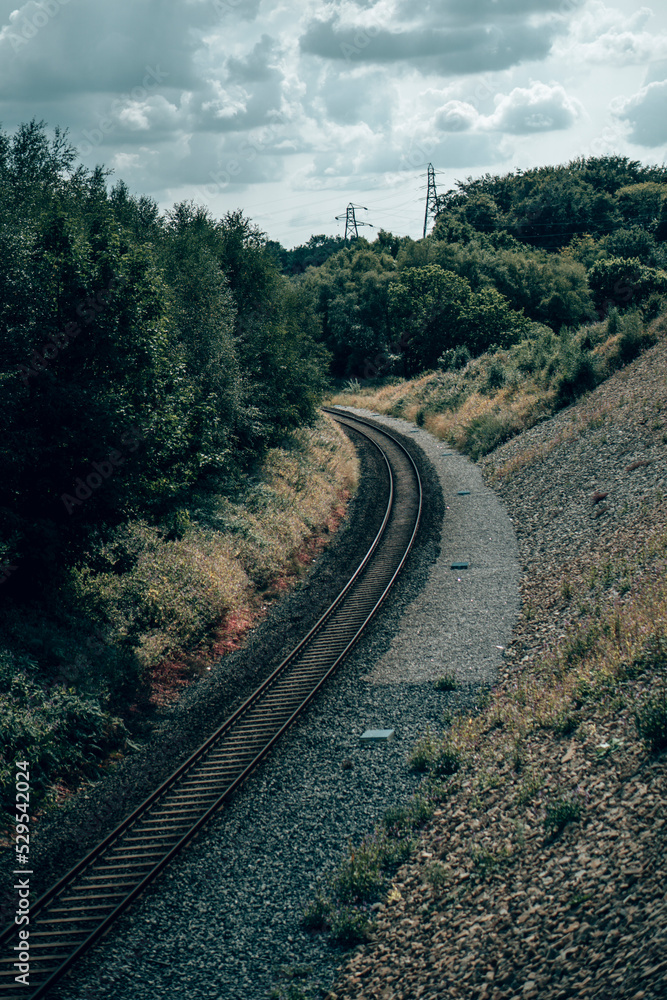 An old rusted train track running through an English forest in Lancashire An old rusted train track running through an English forest in Lancashire
