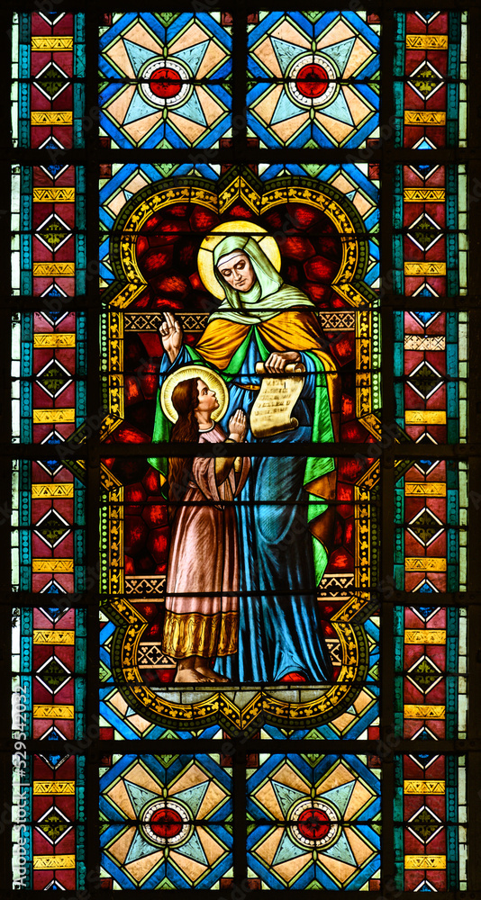 Stained-glass window depicting Saint Anne teaching her daughter, the Virgin Mary. Blumental church in Bratislava, Slovakia. 2021/07/20.
