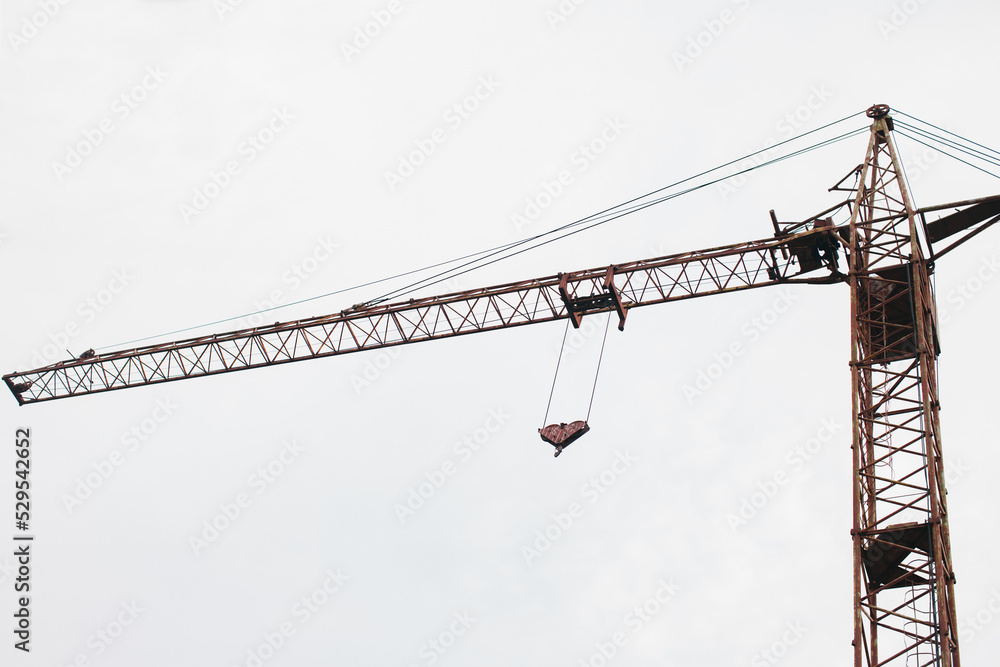 Construction crane on a white sky background.  Bottom view. 