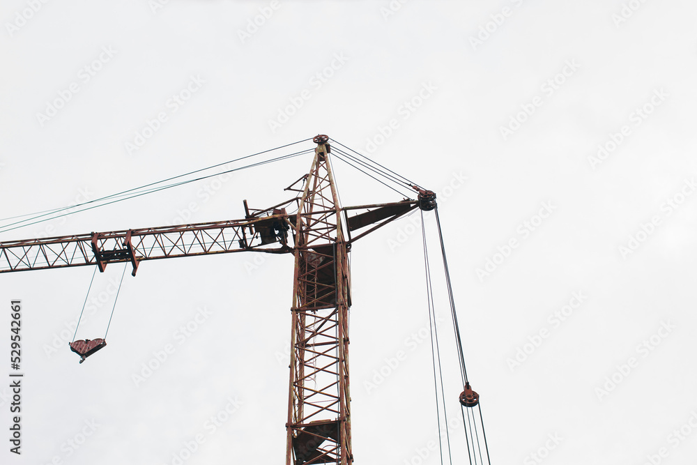 Construction crane on a white sky background.  Bottom view. 