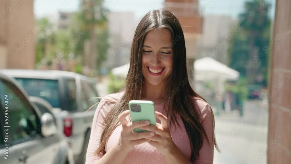Young beautiful hispanic woman smiling confident using smartphone at street Young beautiful hispanic woman smiling confident using smartphone at street