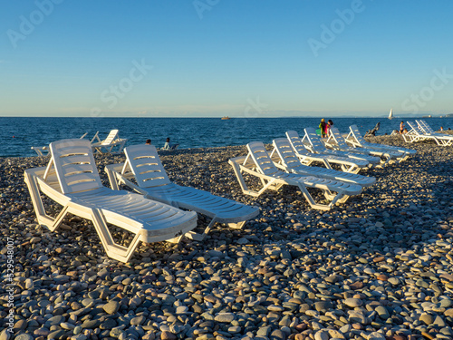 Beach beds. Folded beds. End of the season. On the Sunset. Beach vacation. © Aleksandr