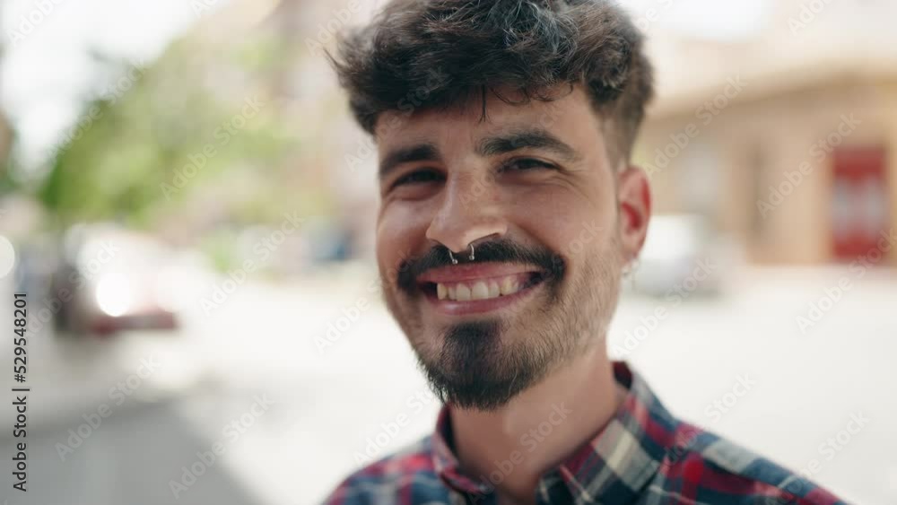 Young hispanic man smiling confident standing with arms crossed gesture at street Young hispanic man smiling confident standing with arms crossed gesture at street