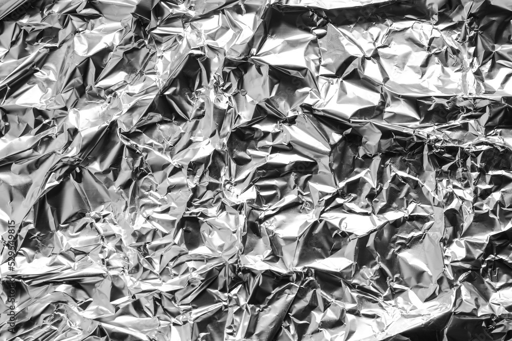 Crumpled silver foil as background, top view Crumpled silver foil as background, top view