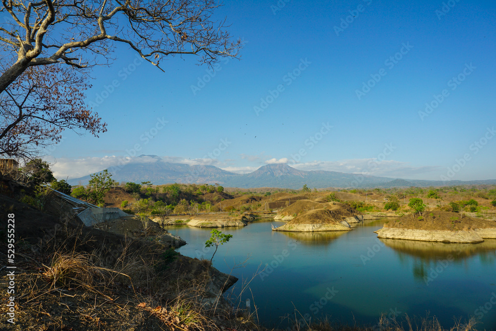 Amazing landscape around Waduk Bajulmati with blue sky, mountains view and lake.