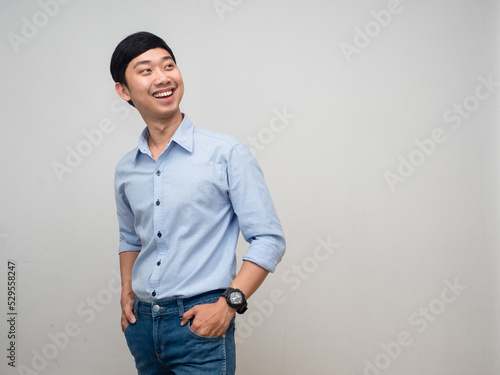 Young businessman happy smile turn around to looking at copy space
