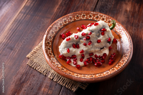 Chile en Nogada, Typical dish from Mexico. Prepared with poblano chili stuffed with meat and fruits and covered with a special walnut sauce. Named as the quintessential Mexican dish. photo