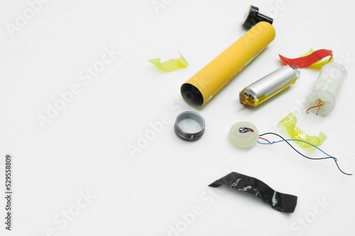 Disassembled into separate parts disposable electronic cigarette. The internal device of the electronic vape for smoking. Repair and disassembly of electronic cigarettes. Selective focus