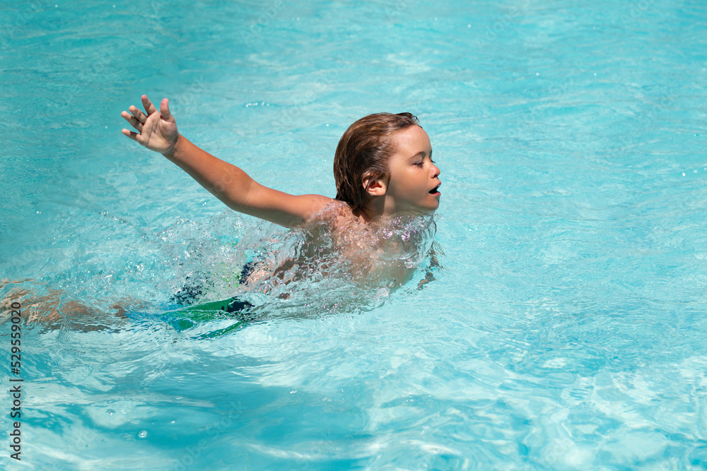 Child splashing in swimming pool. Swim water sport activity on summer vacation with child.