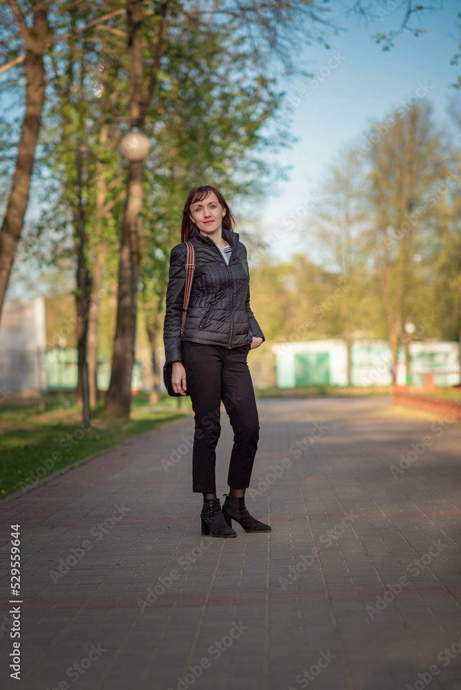 Portrait of a young beautiful dark-haired girl in an autumn park. Portrait of a young beautiful dark-haired girl in an autumn park.