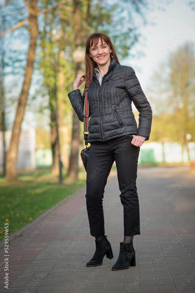 Portrait of a young beautiful dark-haired girl in an autumn park. Portrait of a young beautiful dark-haired girl in an autumn park.