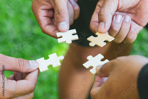 Group of businessperson holding pieces of jigsaw puzzle.