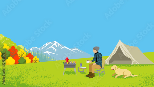 Young man and his dog enjoying camp in autumn nature