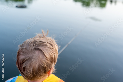 Boy on a fishing with blue water in background