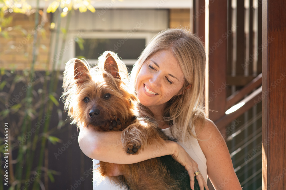 woman cuddling with her dog