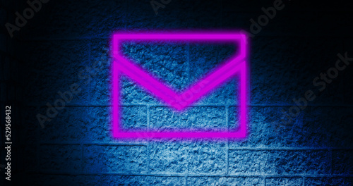 Image of glowing neon envelope icon on brick wall