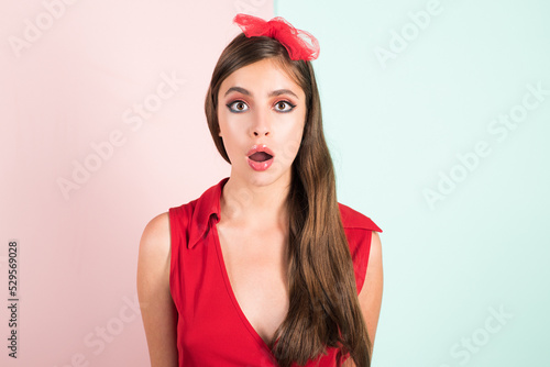 Shocked face of surprised young woman with hair bow. Funny female shocked face expression. Unbelievable. Expressing surprise open mouth.