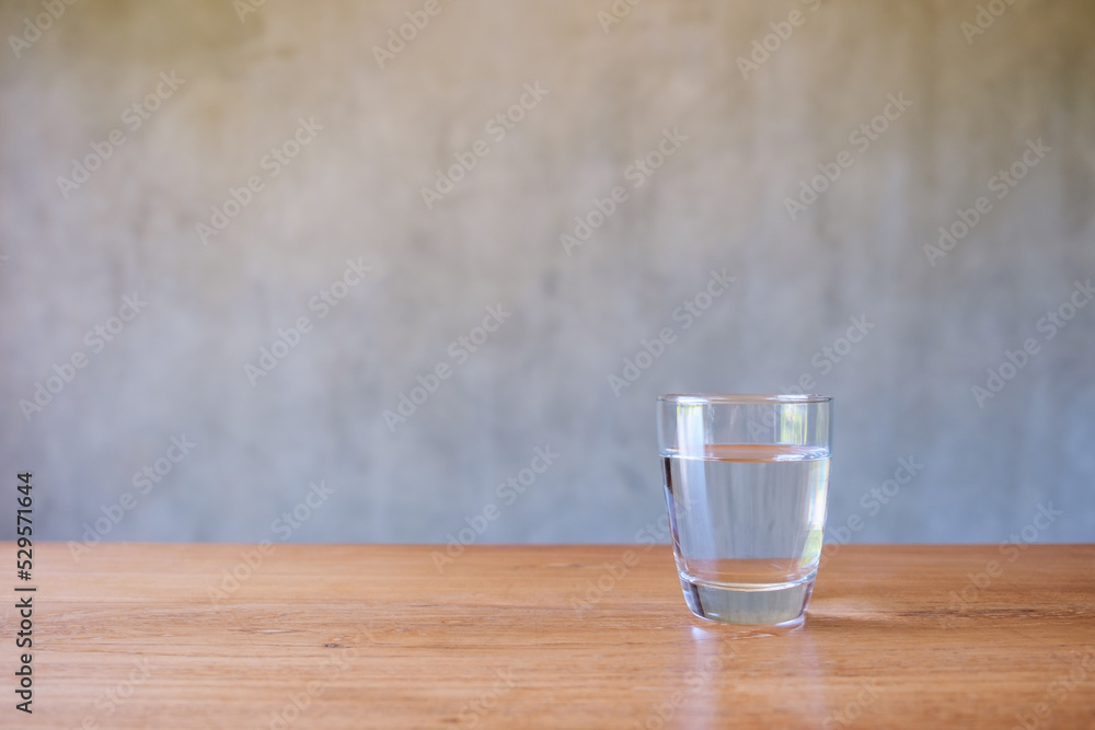 A glass of drinking water on wooden table A glass of drinking water on wooden table
